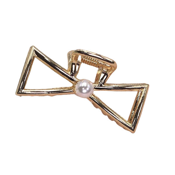 Gold bow-shaped hair clip with a pearl center on a white background