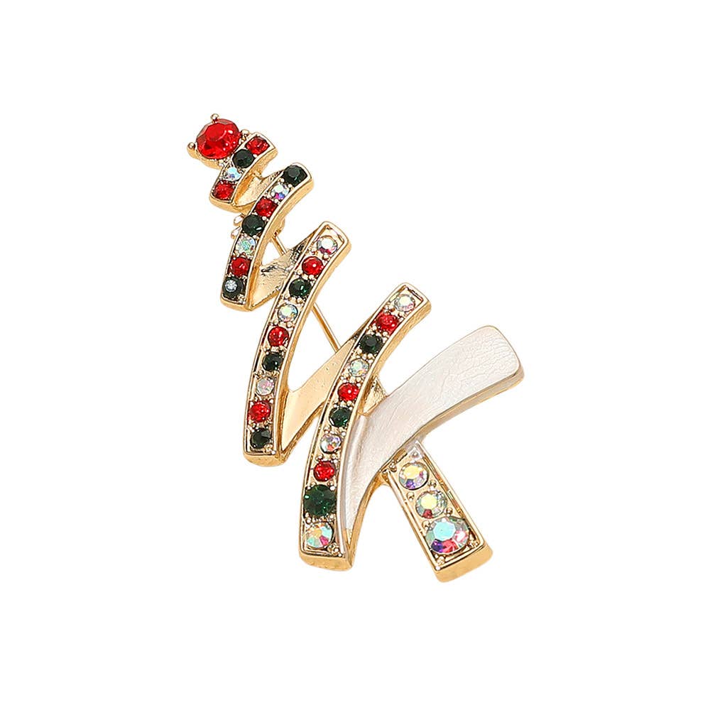 Gold christmas tree brooch with colorful gemstones on a white background
