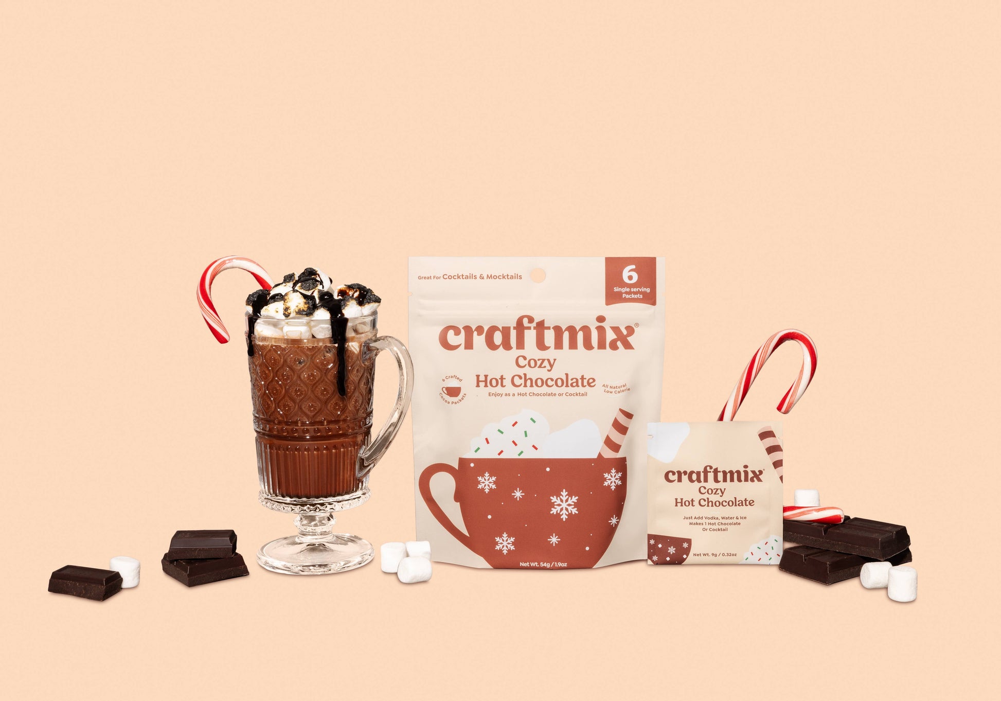 craftmix Cozy Hot Chocolate packaging with a glass of hot chocolate and candy canes on a beige background