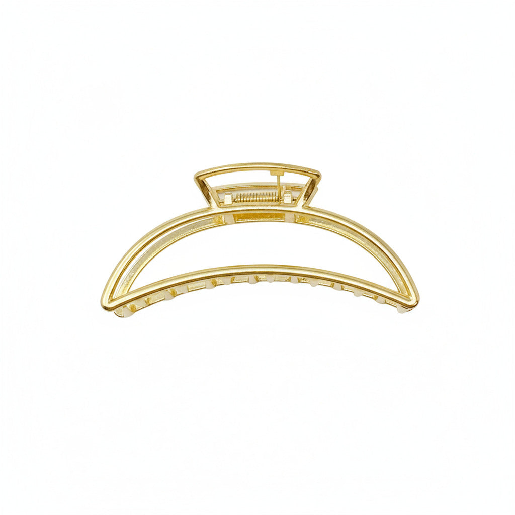 Gold hair clip on a white background