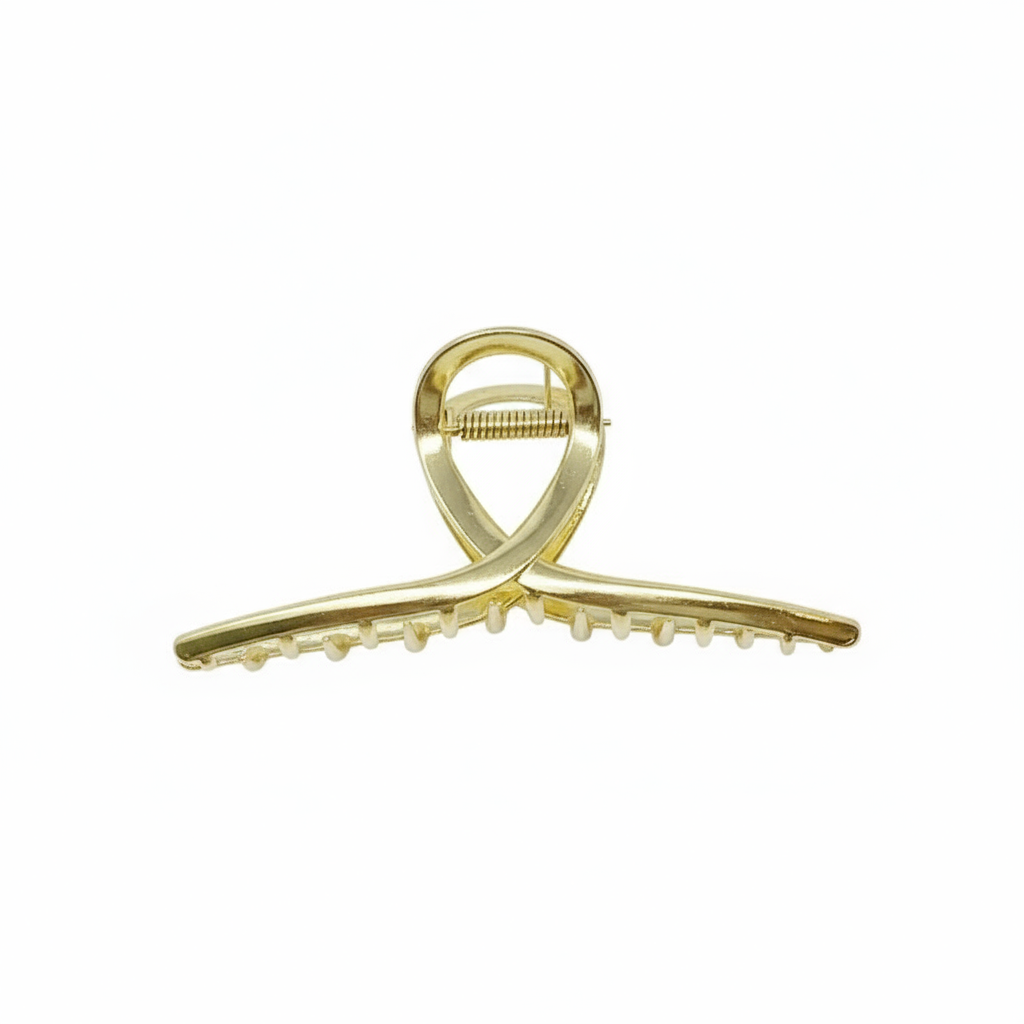 Gold hair clip on a white background