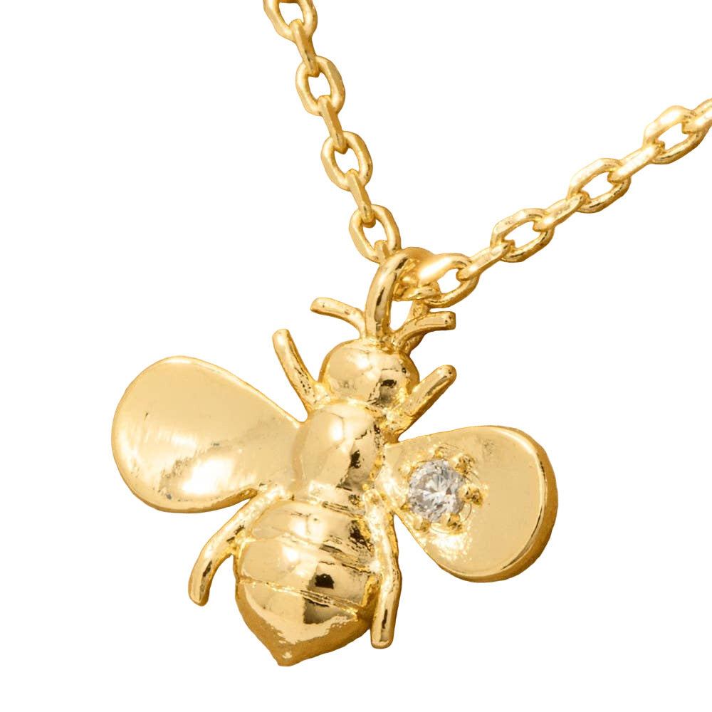 Gold bee pendant necklace with a diamond on a white background