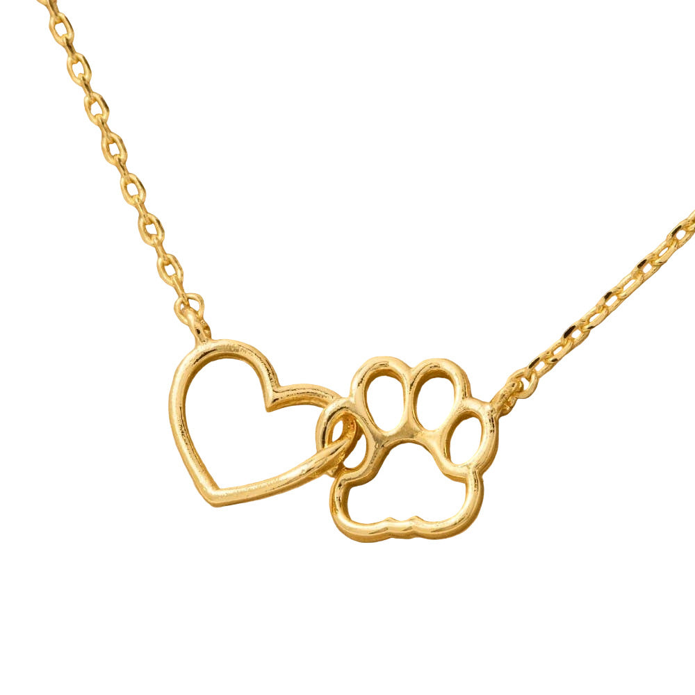 Gold necklace with a heart and paw print design on a brown background