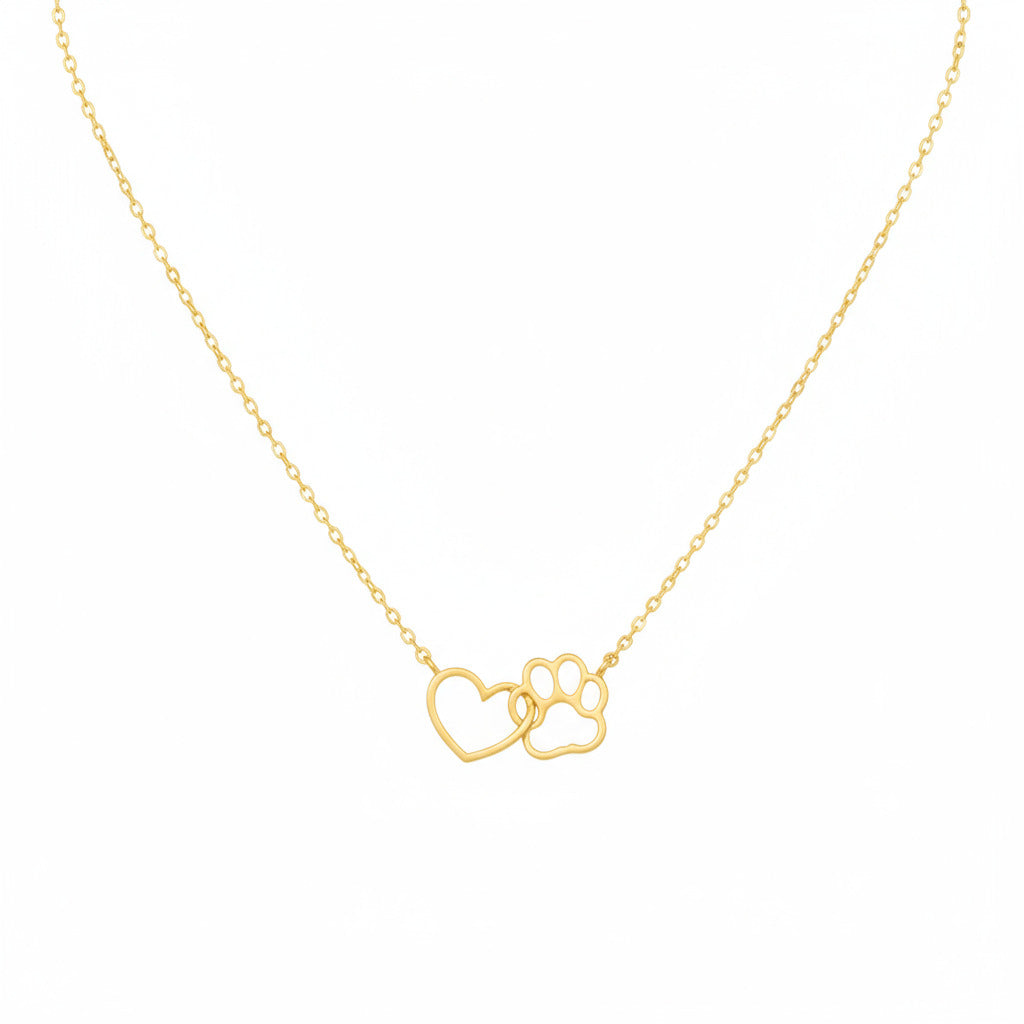 Gold necklace with paw and heart design on a white background.