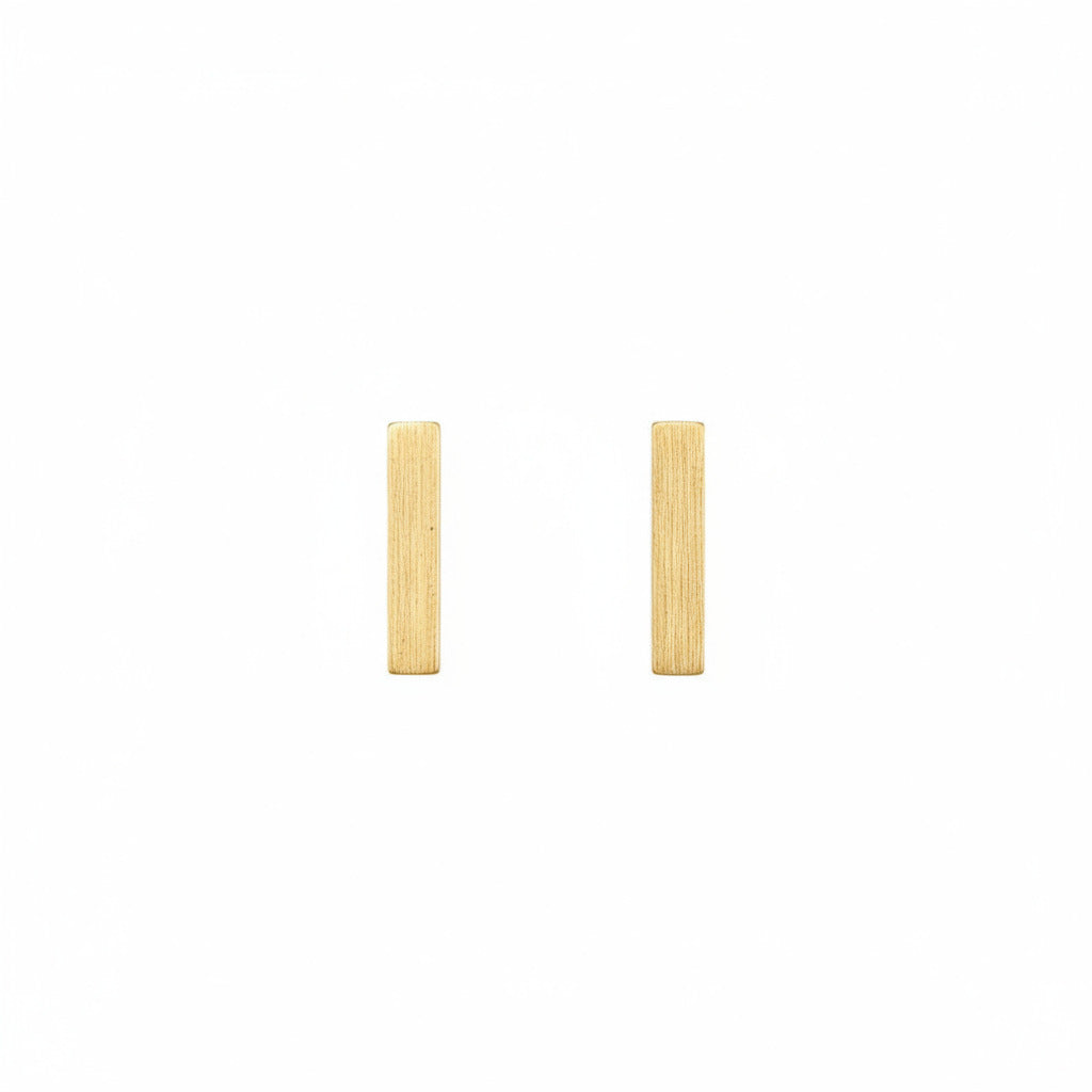 Gold bar earrings on a white background