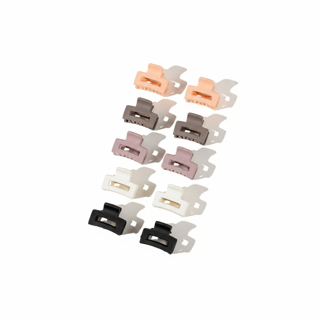 Set of hair clips in various colors on a white surface.
