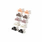 Set of hair clips in various colors on a white surface.