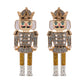 Pair of nutcracker-shaped earrings with glittery details on a white background