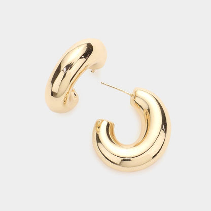 oval gold hoop earrings on a white background