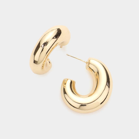 oval gold hoop earrings on a white background