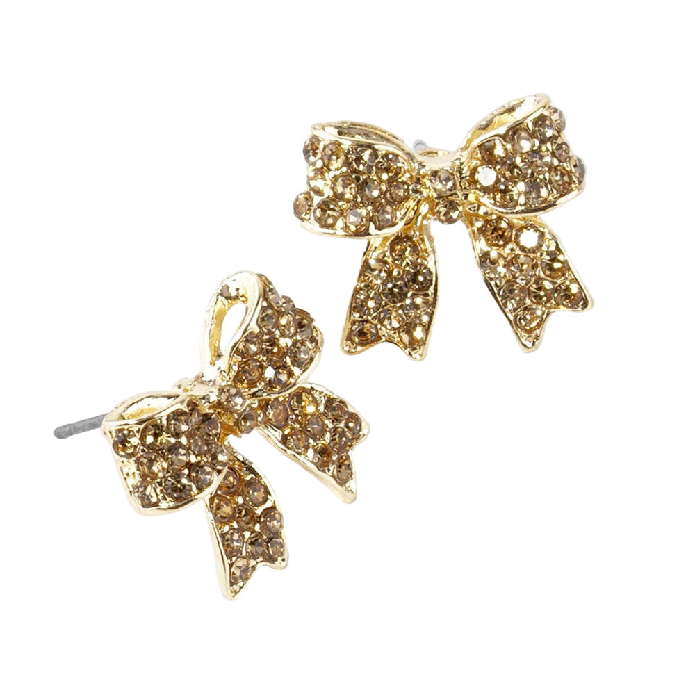 Gold bow-shaped earrings with gemstones on a white background