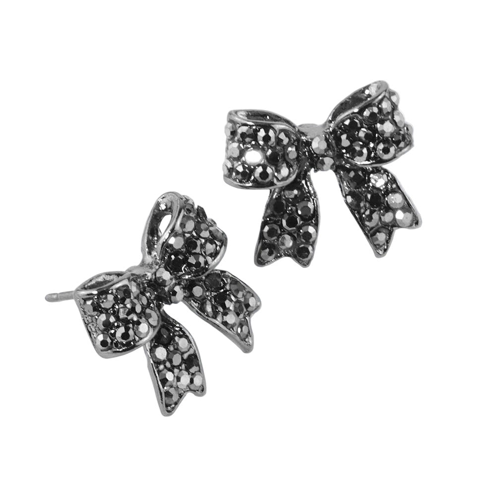 Bow-shaped earrings with dark silver rhinestones on a white background