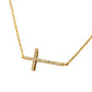 Gold necklace with a diamond-encrusted cross pendant on a white background