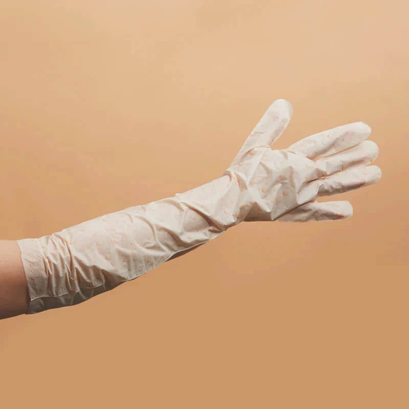 White disposable glove on a beige background