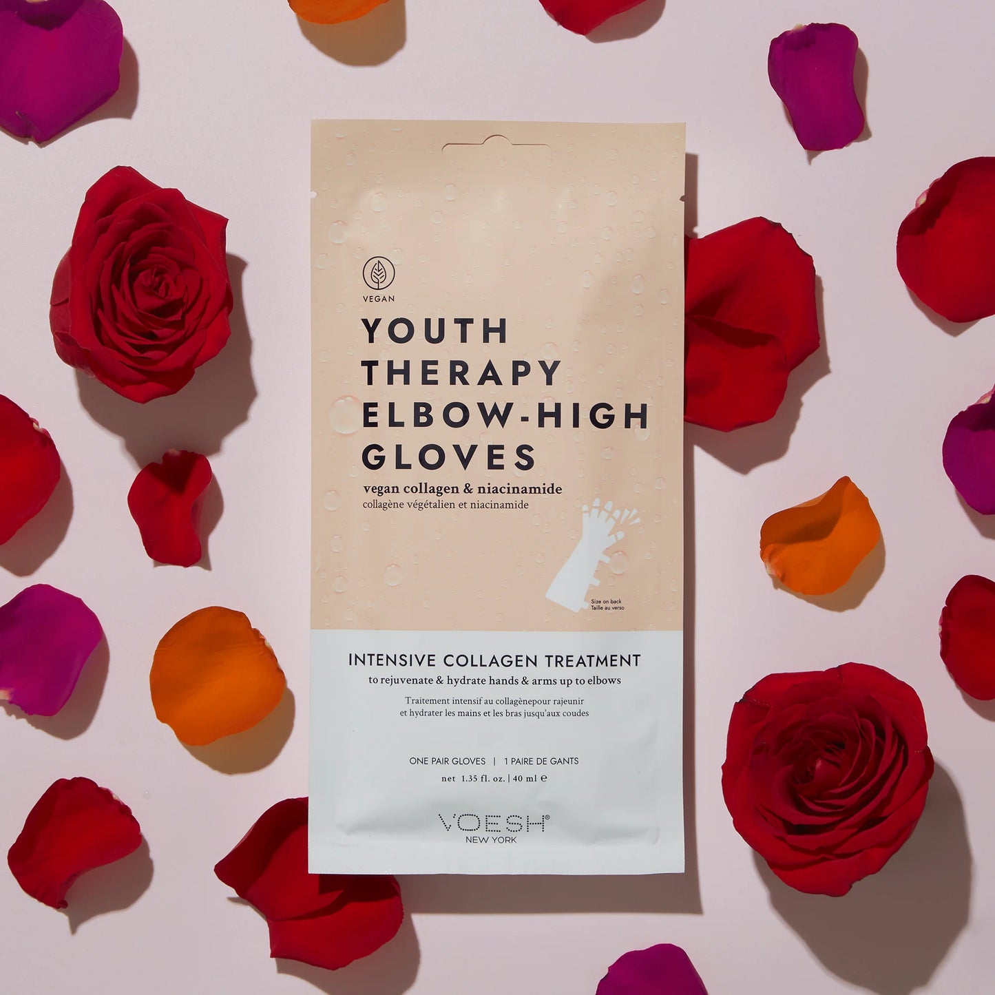 Yoesh Youth Therapy Elbow-High Gloves packaging surrounded by red roses on a light pink background